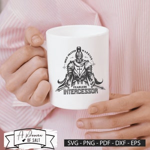 May include: White ceramic mug with a black and white illustration of a knight holding swords. The text "Bold Prayer Warrior Fearless Intercessor" is printed on the mug.