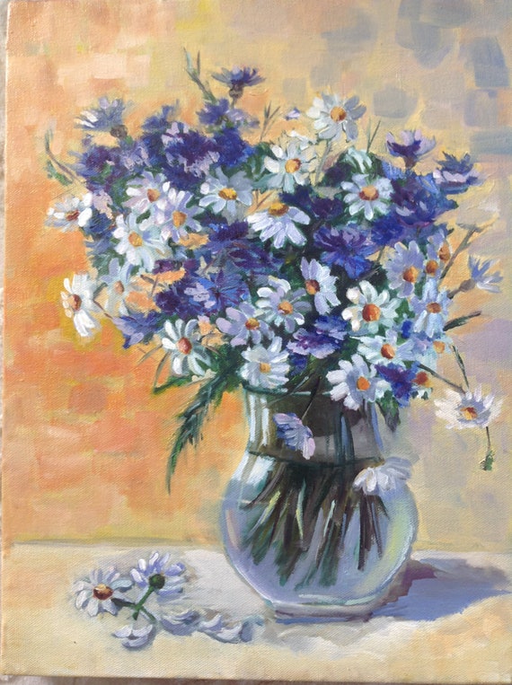 Flowers in a vase, camomile and cornflower