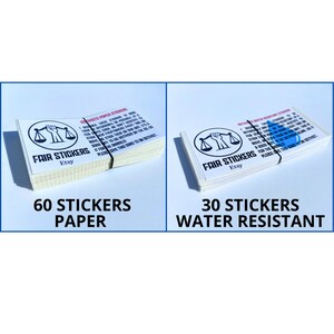May include: Two stacks of stickers with a black and white illustration of a fist holding a scale. The top stack is labeled "60 Stickers Paper" and the bottom stack is labeled "30 Stickers Water Resistant".