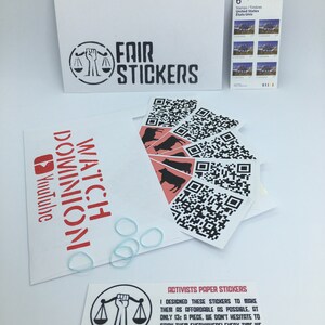 May include: A set of six black and white stickers with a scale and a raised fist. The stickers are designed to be used as activism tools. The text on the card reads "Activists Paper Stickers" and "I designed these stickers to make them as affordable as possible. At only 13&cent; a piece, we don't hesitate to stick them everywhere! Every time we move, we stick them on our way. It's a good way to do activism on the go. Do it for the animals! Please give this card to an activist."