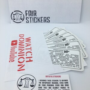May include: A white card with black text that reads "Artistic Stickers". The card features a black and white illustration of a scale with a raised fist. The text below the illustration reads "Fair Stickers Etsy".