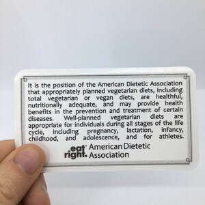 May include: A white card with black text stating that the American Dietetic Association supports appropriately planned vegetarian diets. The card also includes the text "eat right. Association".