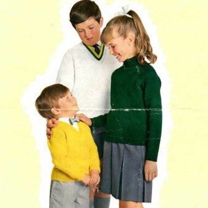 May include: Three children wearing school uniforms. A boy in a white sweater with a green and yellow collar is standing with his arm around a boy in a yellow sweater and grey shorts. A girl in a green sweater and grey skirt is standing next to the boys.