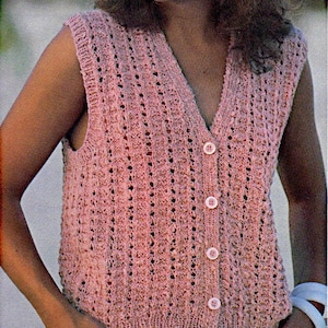 May include: A pink crocheted sleeveless vest with a button-up front.