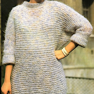 May include: A light blue fuzzy knit jumper with a round neckline and long sleeves.