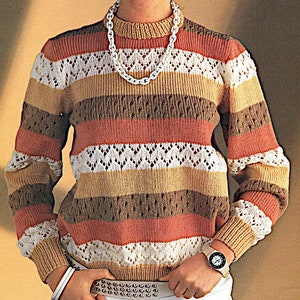 May include: A striped sweater with a white crocheted pattern. The sweater has long sleeves and a round neckline. It is made of a soft, warm yarn and is perfect for layering in the fall or winter.