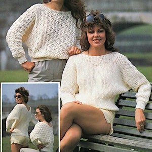 May include: Cream-colored knit sweaters with long sleeves. One sweater has a diamond pattern, while the other has a plain knit. The sweaters are paired with shorts. The image shows a woman wearing sunglasses and sitting on a bench.