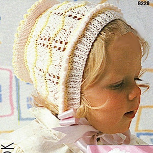 May include: A white crocheted baby bonnet with a yellow trim. The bonnet is worn by a baby with blonde hair. The bonnet has a scalloped edge. The image also shows a close-up of the bonnet on a different baby.