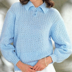 May include: A light blue knitted jumper with a collar and button fastening. The jumper features a delicate openwork design.