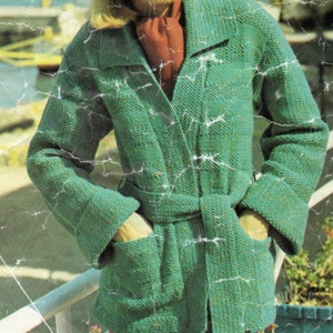 May include: A green knitted jacket with a belt and pockets. The jacket has a collar and long sleeves.