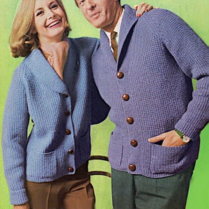 May include: Two people wearing matching blue waffle knit cardigans with brown buttons. The cardigans have pockets and a shawl collar.