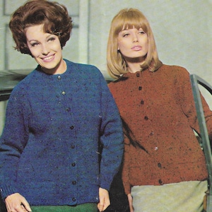 May include: Two women wearing knitted cardigans. The woman on the left is wearing a blue cardigan with a button-up front. The woman on the right is wearing a brown cardigan with a button-up front.