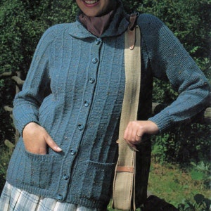 May include: A blue knitted cardigan with a button-up front, two pockets, and a collar. The cardigan is worn over a plaid skirt.