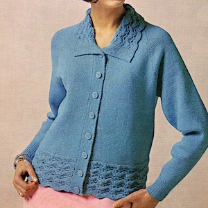May include: A light blue knitted cardigan with a button-up front and a decorative collar. The cardigan has a textured pattern on the collar and hem.