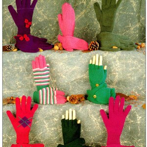 May include: A collection of eight pairs of knitted gloves in various colors and patterns, including purple, pink, green, and red. The gloves are displayed on a textured surface with pine cones and nuts.