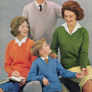 May include: A family of four wearing sweaters. The father is wearing a light gray sweater with a dark blue tie. The mother is wearing a green sweater. The daughter is wearing an orange sweater and the son is wearing a blue sweater.