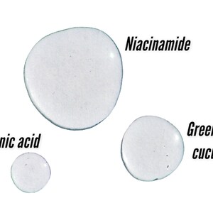 May include: Clear liquid droplets labeled "Hyaluronic acid", "Niacinamide", and "Green tea + cucumber" against a white background. The droplets vary in size and shape, suggesting different viscosities.