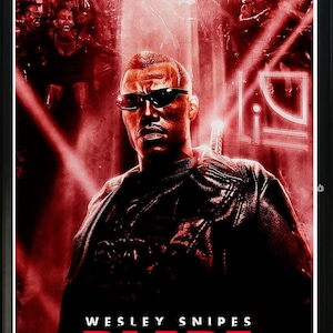 May include: A red and black movie poster featuring Wesley Snipes as Blade, a vampire hunter. The poster has the title "Blade" in large red letters and the text "Wesley Snipes" in smaller white letters.