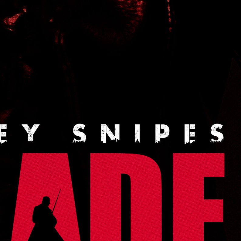 May include: A movie poster with a red background and the text "Blade" in large white letters. The text "Wesley Snipes" is above the title in smaller white letters.