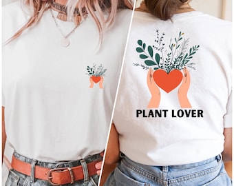 May include: White t-shirt with a green plant and red heart graphic on the front and the text "PLANT LOVER" on the back.