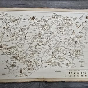 Puede incluir: Un mapa detallado de Hyrule, una tierra ficticia de la serie de videojuegos The Legend of Zelda. El mapa está dibujado en blanco y negro sobre una superficie de madera marrón claro. El mapa muestra varias regiones, incluyendo Hyrule Field, Gerudo Desert y Death Mountain.