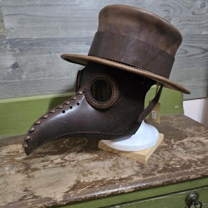 Leather Top Hat and Plague Doctor Mask.