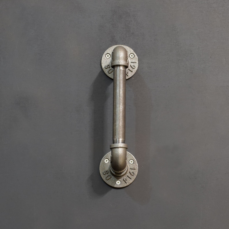 May include: A metal pipe handle with two round flanges. The flanges are marked with the numbers "1161" and "1161".