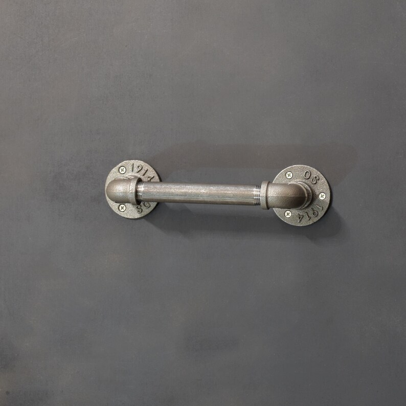 May include: A silver metal pipe with two round flanges. The flanges have the numbers "1914" and "081914" on them.