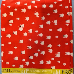 May include: Red fabric with a repeating pattern of white cartoon frogs with pink accents. The fabric has a white border with the text "STEEL", "SARAH WATTS", and "FRC".