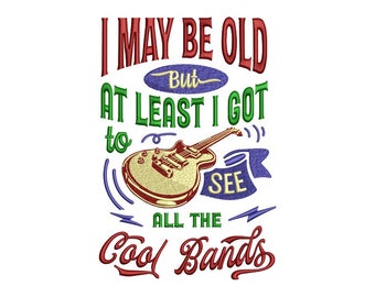 May include: Red, green, and blue embroidered text reads "I may be old but at least I got to see all the cool bands". A yellow electric guitar with red and brown details is in the center of the text.