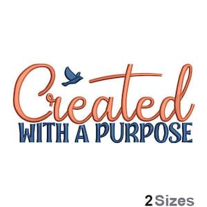 May include: Embroidered design with a peach-colored cursive font that reads "Created with a Purpose" and a blue bird flying above the word "Created".