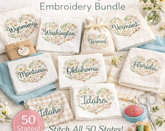May include: A collection of white embroidered towels and a small bag, each featuring a state name within a floral heart design. The text "Floral State Hearts Embroidery Bundle" is at the top, with "50 States!" and "Stitch All 50 States!" at the bottom.