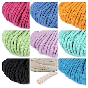 May include: A selection of colourful macrame cords in shades of pink, blue, orange, green, purple, teal, black, beige, and turquoise. The cords are tightly woven and appear soft, suitable for crafting projects.