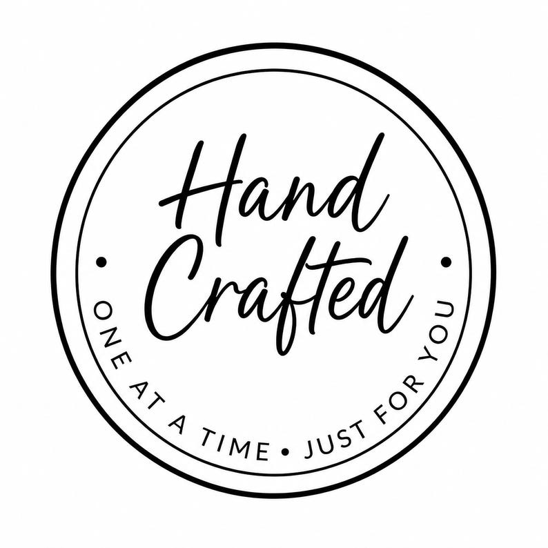 A black and white circular logo with the script text Hand Crafted in the center and the words ONE AT A TIME JUST FOR YOU along the bottom curve.