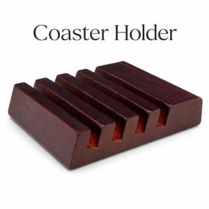 A dark brown wooden coaster holder with four slots, and the text "Coaster Holder" above it.