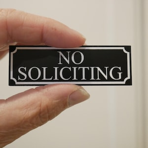Doorbell | no soliciting sign | black with white lettering | no solicitation