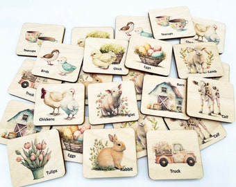 May include: A collection of square wooden tiles featuring watercolor illustrations of farm animals, flowers, and objects. Each tile displays a specific image such as a piglet, rabbit, lamb, calf, chickens, eggs, barn, truck, tulips, and teacups with labels.