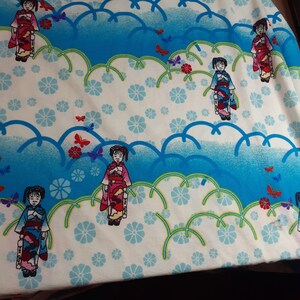 May include: White fabric with a repeating pattern of blue clouds, green leaves, white flowers, and butterflies.  The fabric features a repeating pattern of girls wearing traditional Japanese clothing.