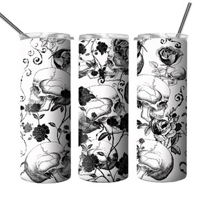 May include: Three stainless steel tumblers with a black and white design of skulls and roses. The tumblers have lids and straws.