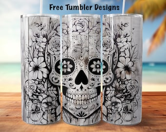 May include: Three stainless steel tumblers with a white woodgrain background and a black and white sugar skull design with floral accents.