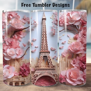 May include: Three stainless steel tumblers with a design featuring the Eiffel Tower and pink paper flowers. The tumblers are on a wooden surface.