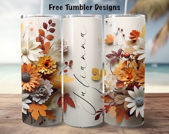 May include: Three stainless steel tumblers with a fall floral design. The tumblers feature a white background with orange, brown, and cream paper flowers and leaves. One tumbler has the name "Julianna" written in black cursive.