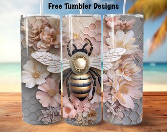 May include: Three tumblers with a bee and floral design. The central tumbler features a detailed bee with gold and black accents, surrounded by pink and cream-colored flowers. The background has a honeycomb pattern and the text "Free Tumbler Designs".
