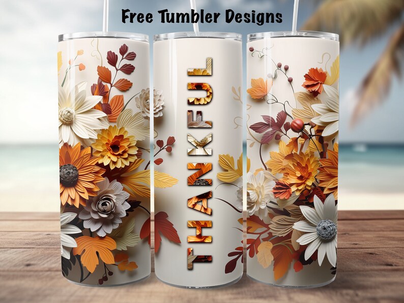 May include: Three white tumblers with a fall floral design. The center tumbler has the word "THANKFUL" in orange and brown letters.