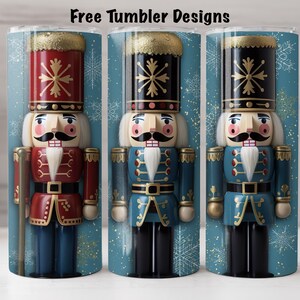 May include: Three different designs of a Christmas nutcracker tumbler. The tumblers are all blue with gold snowflakes and a nutcracker in the centre. The nutcracker on the left is wearing a red and gold uniform, the middle nutcracker is wearing a blue and gold uniform, and the nutcracker on the right is wearing a blue and gold uniform.