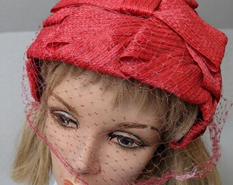 Vintage 1950s, Red Woven Juliette Casque Cap Hat with netted veil and big bow. Popular style for a 50s hat and perfect for the holidays.