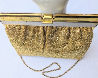 Vintage 1950s, Gold Lamé Evening Bag. Unique clasp that closes firmly. Gold tone chain works as shoulder bag or doubled up for a wrist bag.