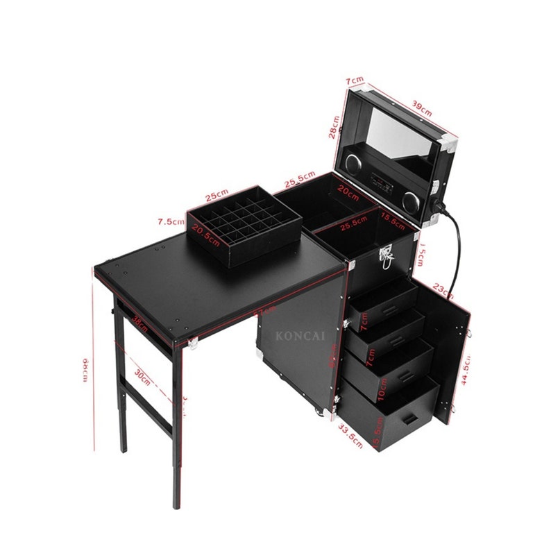 May include: A black rolling makeup case with a fold-out table, drawers, and a top compartment with a mirror. The table is 38 cm wide and 30 cm tall. The case has a black exterior with silver-colored trim.