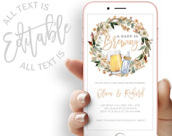 May include: A baby shower invitation displayed on a smartphone. The invitation features a watercolor design with the text "A Baby is Brewing" surrounded by a floral wreath. The invitation includes details for Olivia & Richard's baby shower.