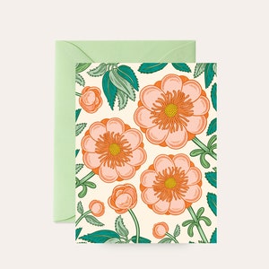 May include: A greeting card with a floral pattern. The card features a white background with pink and orange flowers and green leaves.